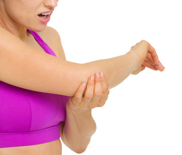 Etiopathe Paris: tendinite du coude tennis elbow femme-qui-se-tient-le-coude-et-qui-grimace